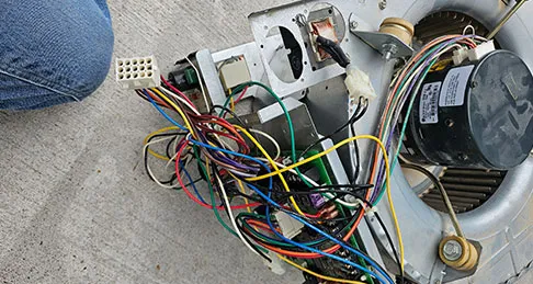 A blower assembly with its control wiring laid out for repair