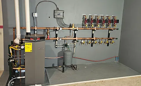 The finished boiler room, with a new boiler, copper piping and manifolds