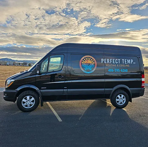 The black Perfect Temp van under a big evening sky
