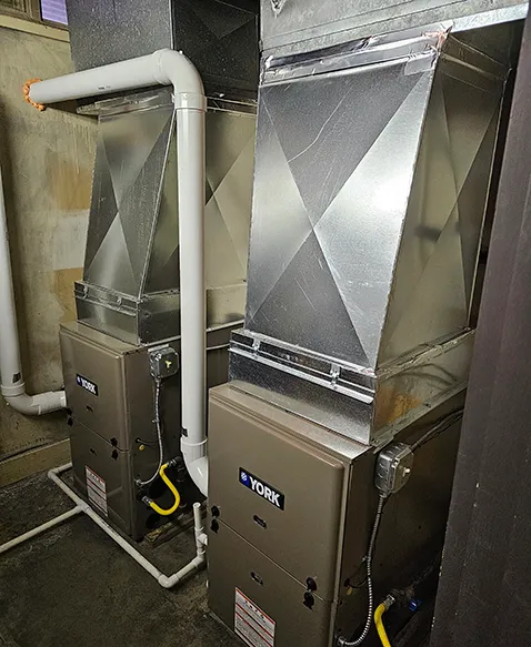 Two new York furnaces with new ductwork in the same basement